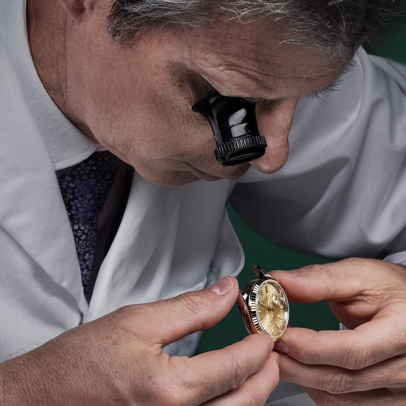 Rolex jeweler inspecting watch with a loupe