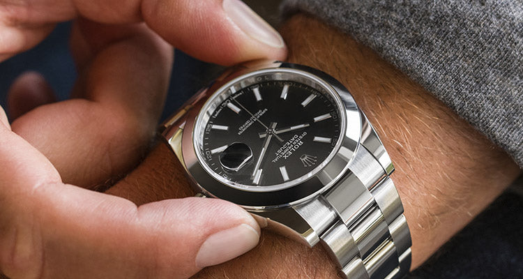 Man adjusting Rolex watch on his wrist