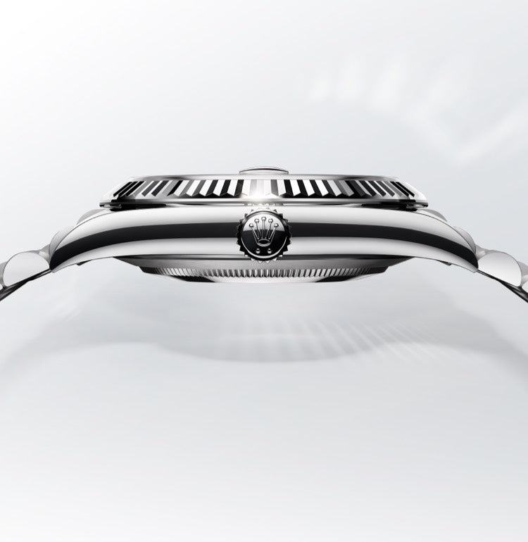 Side view of a steel Rolex watch with crown