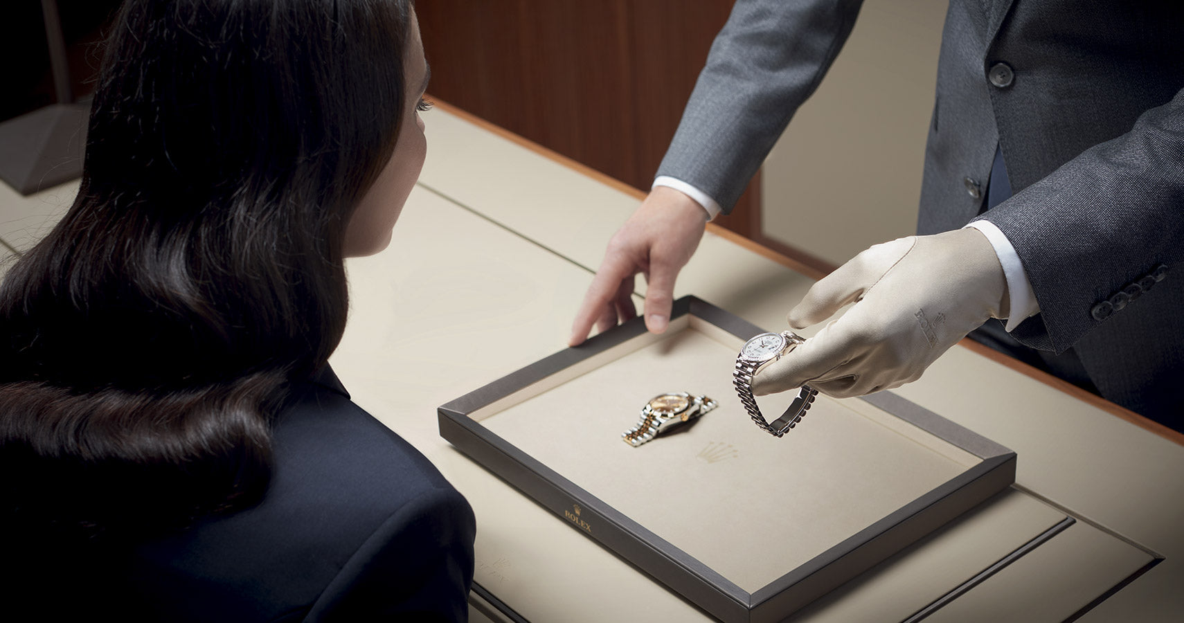 Jeweler presenting a Rolex watch to a client