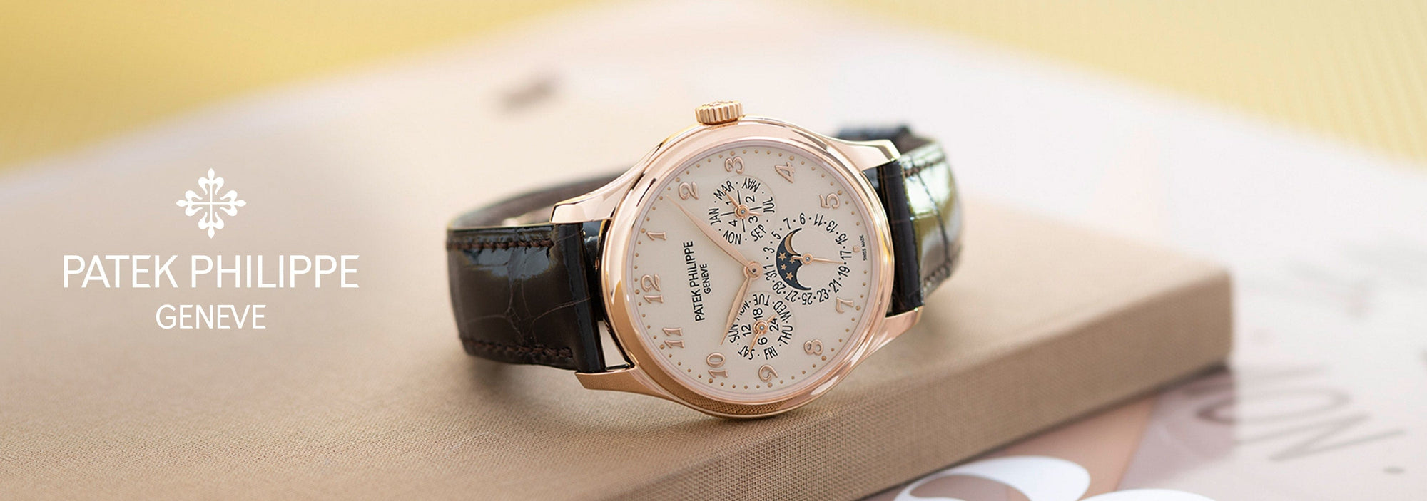 Patek Philippe watch on a light surface with 'Patek Philippe Geneve' branding.