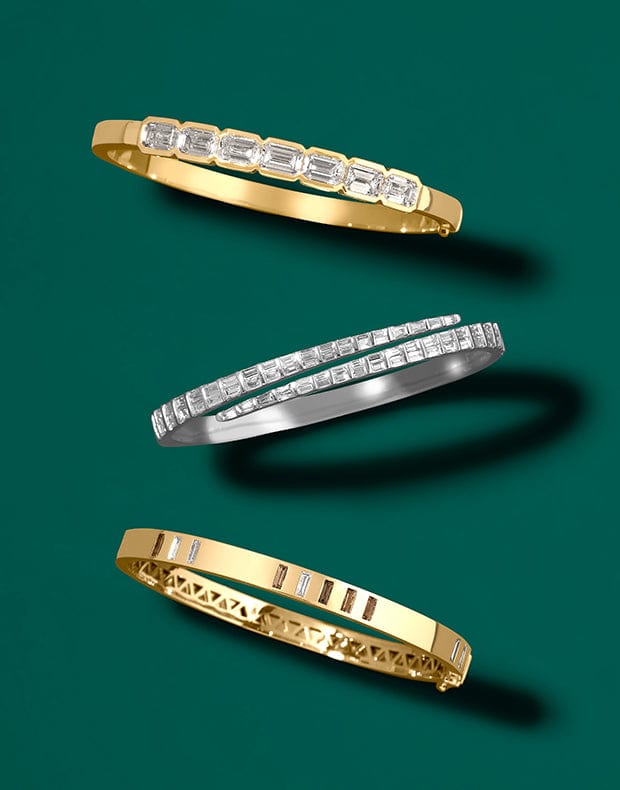 Three gold and silver rings on a green background