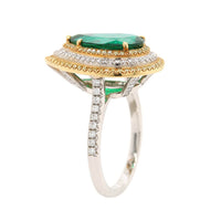 Platinum and 18K Yellow Gold Pear Shaped Emerald and Diamond Halo Ring