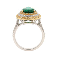 Platinum and 18K Yellow Gold Pear Shaped Emerald and Diamond Halo Ring