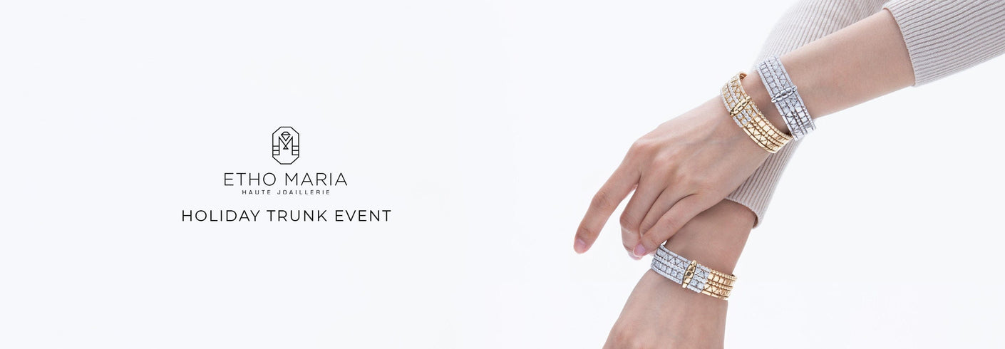 Hand wearing multiple bracelets with Etho Maria logo on a white background