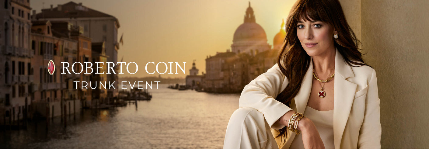 Dakota Johnson in a white suit with jewelry against a scenic background, promoting Roberto Coin trunk event.