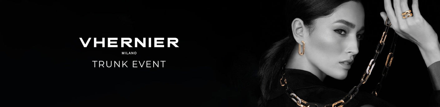 Vhernier trunk event featuring a woman wearing jewelry against a black background.
