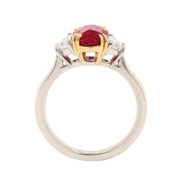 Platinum and 18K Yellow Gold Oval Ruby & Trap Cut Diamond Three Stone Ring
