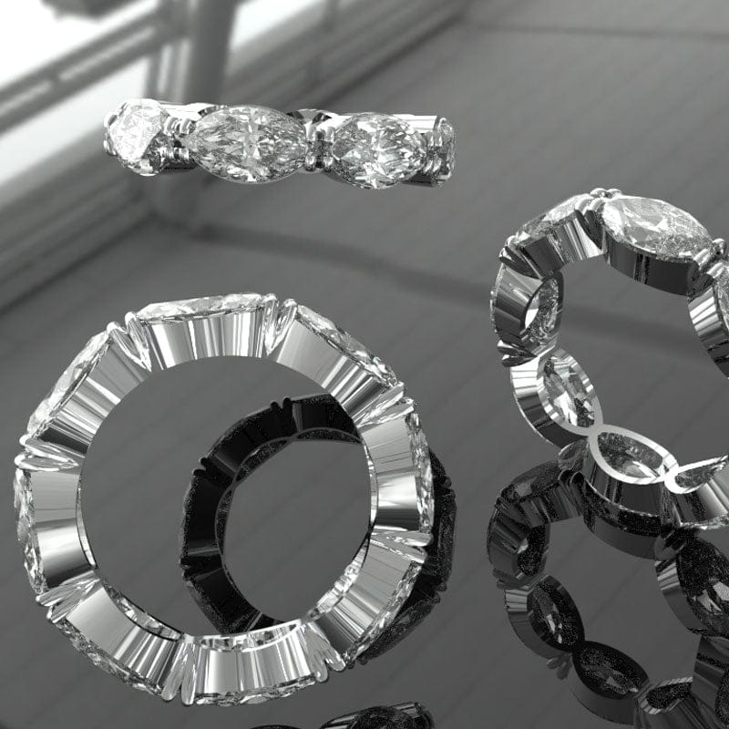 Close-up of various diamond rings on a reflective surface