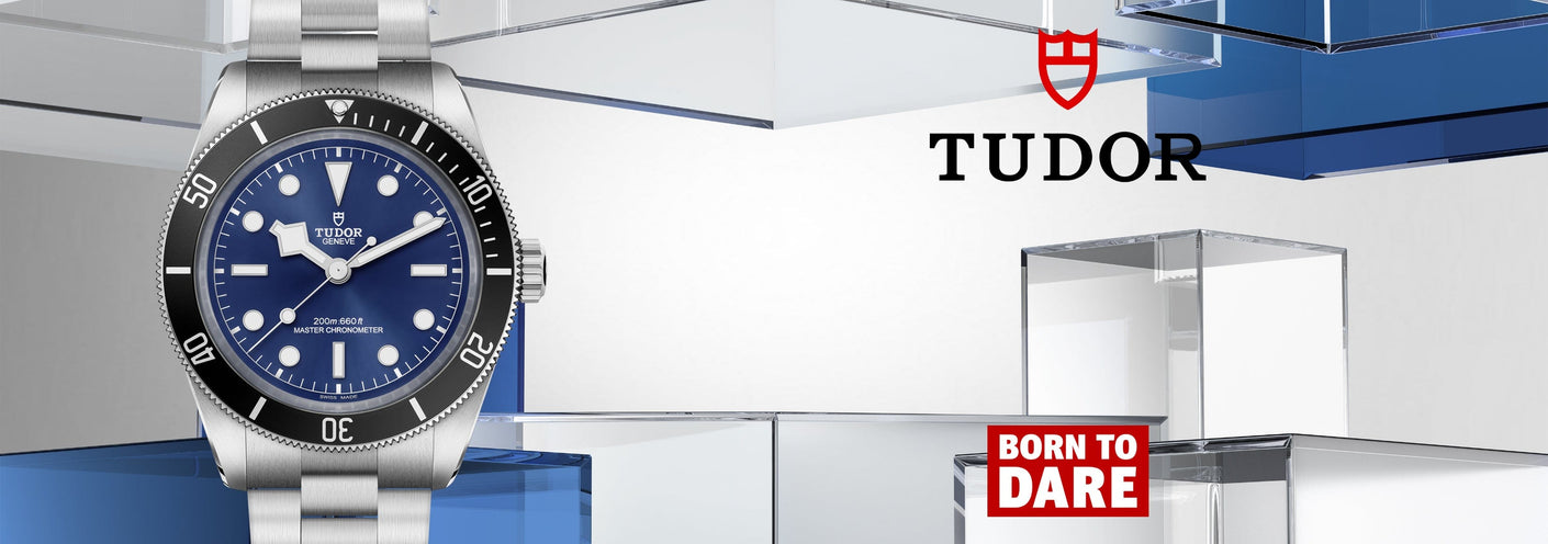 Tudor watch with blue face and silver case on a modern background
