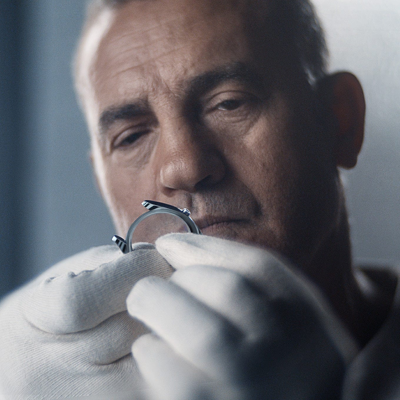 Rolex jeweler inspecting bezel