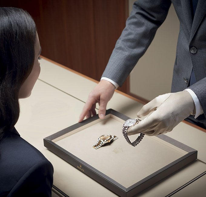 Jeweler presenting a Rolex watch to a client