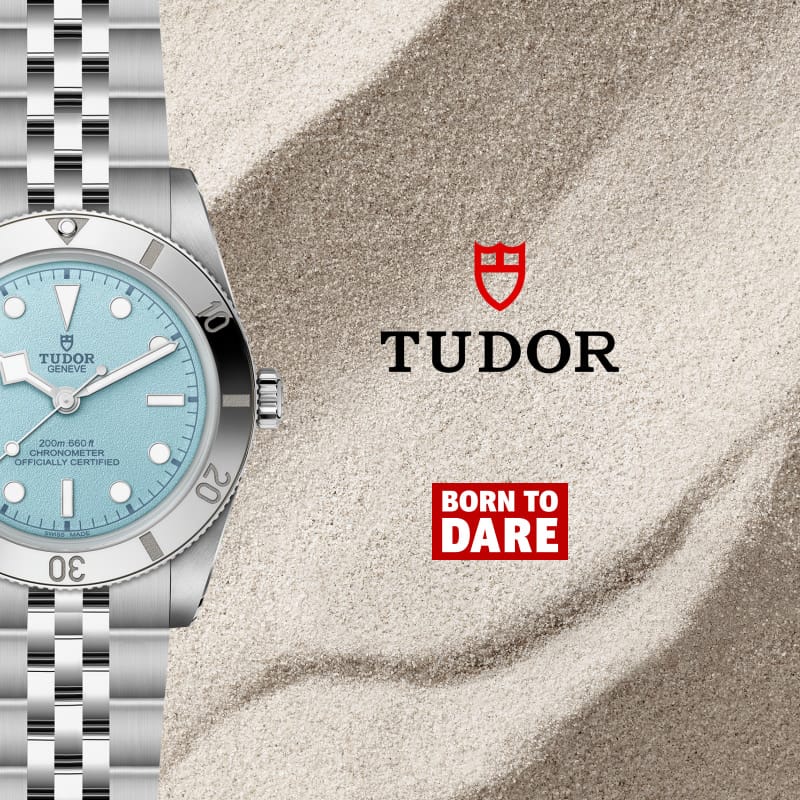 TUDOR watch light blue face on sand background