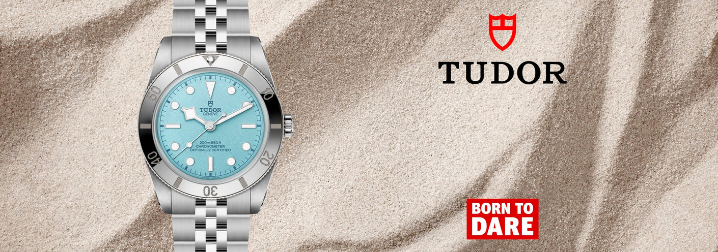 TUDOR watch light blue face on sand background
