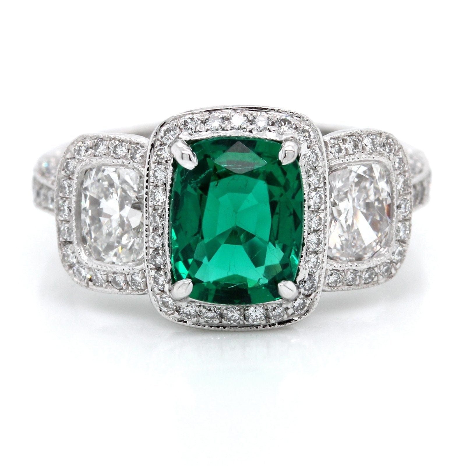 Platinum Three-Stone Emerald and Diamond Halo Ring