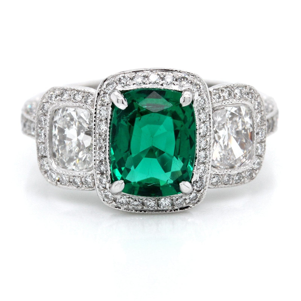 Platinum Three-Stone Emerald and Diamond Halo Ring