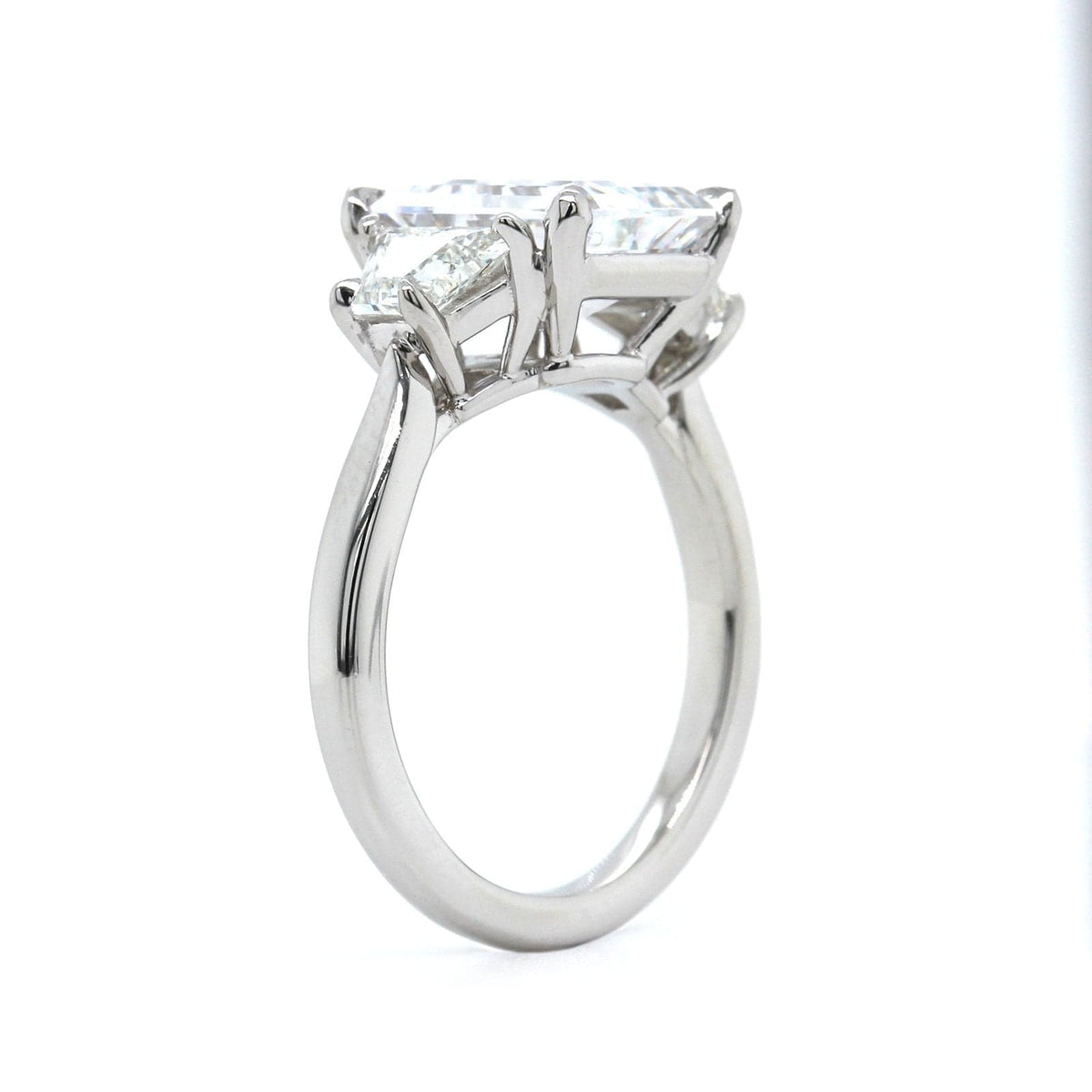 Platinum 3 Stone Emerald Cut Diamond with Trapezoid Sides Engagement Ring Setting