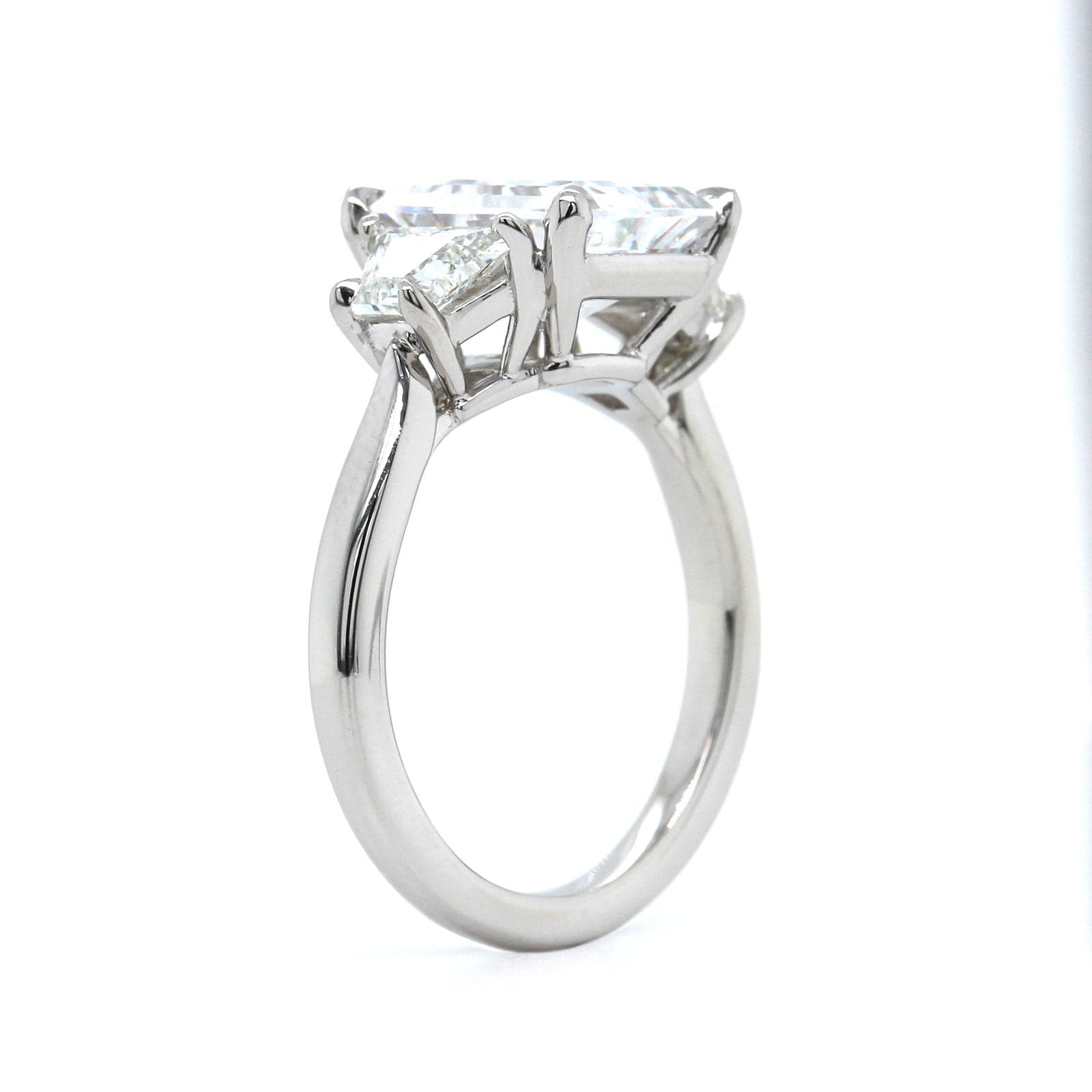 Platinum 3 Stone Emerald Cut Diamond with Trapezoid Sides Engagement Ring Setting
